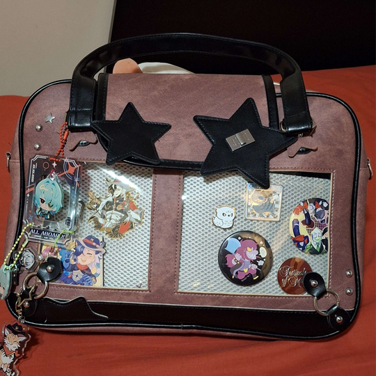This my ita bag, a style of bag that's designed to show off pins and keychains with a speacial clear compartment to attach them to. The point of an ita bag it to bring attention to the obejcts in it, and I think adding lights could help emphasize this purpose further than it curently is